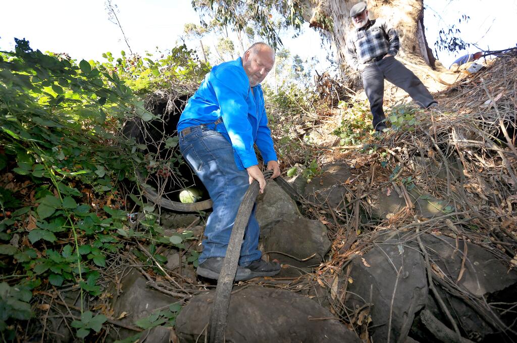 Roger Larsen, left and Dennis Guggemos inspect Stemple Creek for debris, Monday Aug. 25, 2014, adjacent to the Sonoma County Landfill. (Kent Porter / Press Democrat) 2014