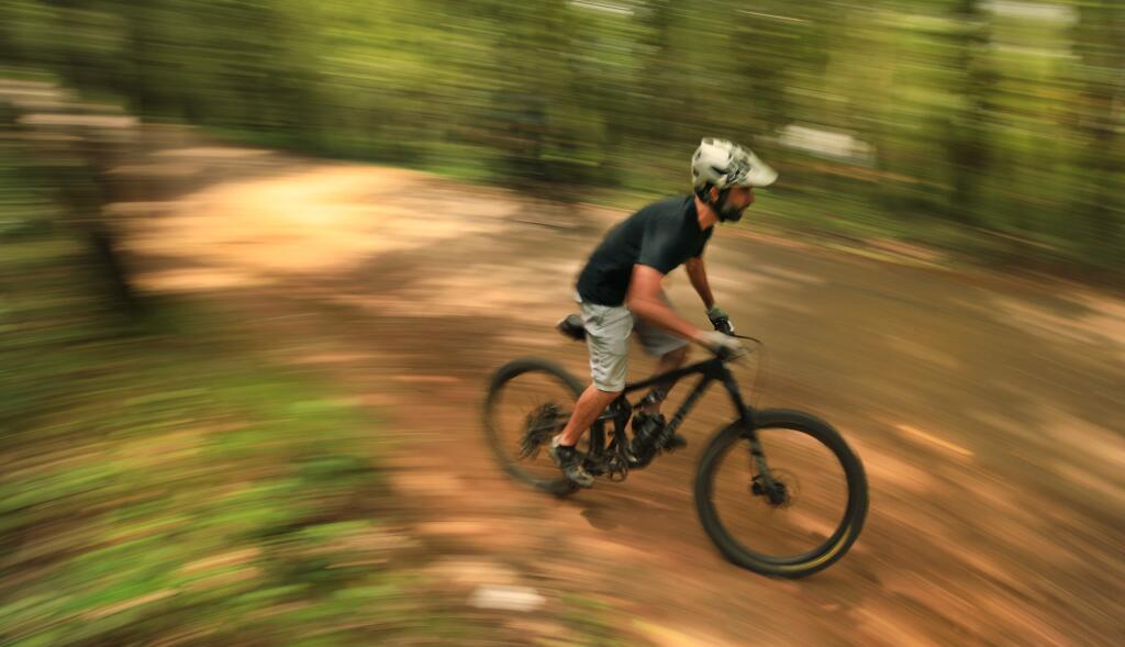 A mountain biker speeds up a trail at Howarth Park, Wednesday, April 29, 2020. The county opened municipal parks after weeks of shelter in place restrictions. The only caveat is residents can only bike or walk to the park and maintain social distancing. (Kent Porter / The Press Democrat) 2020