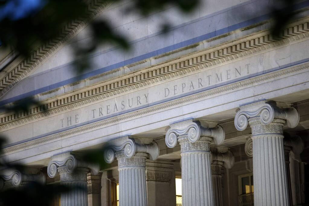 This June 6, 2019, file photo shows the U.S. Treasury Department building at dusk in Washington. (AP Photo/Patrick Semansky, File)