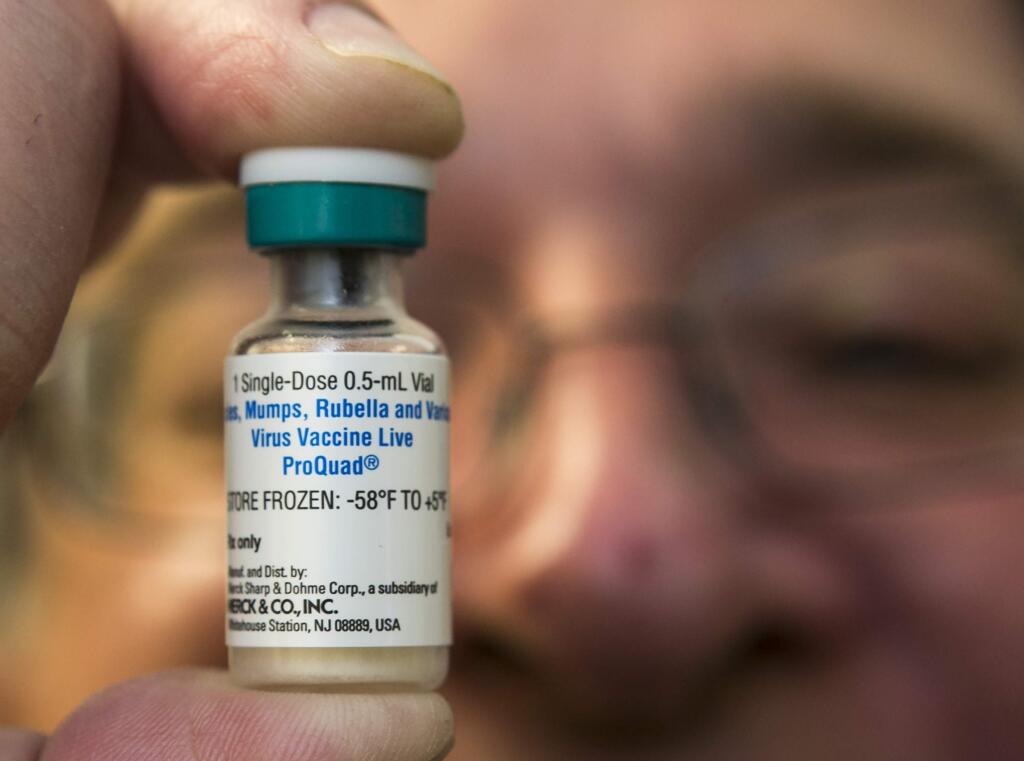 A pediatrician holds a dose of the measles-mumps-rubella vaccine at his practice in Northridge. (DAMIAN DOVARGANES / Associated Press, 2015)