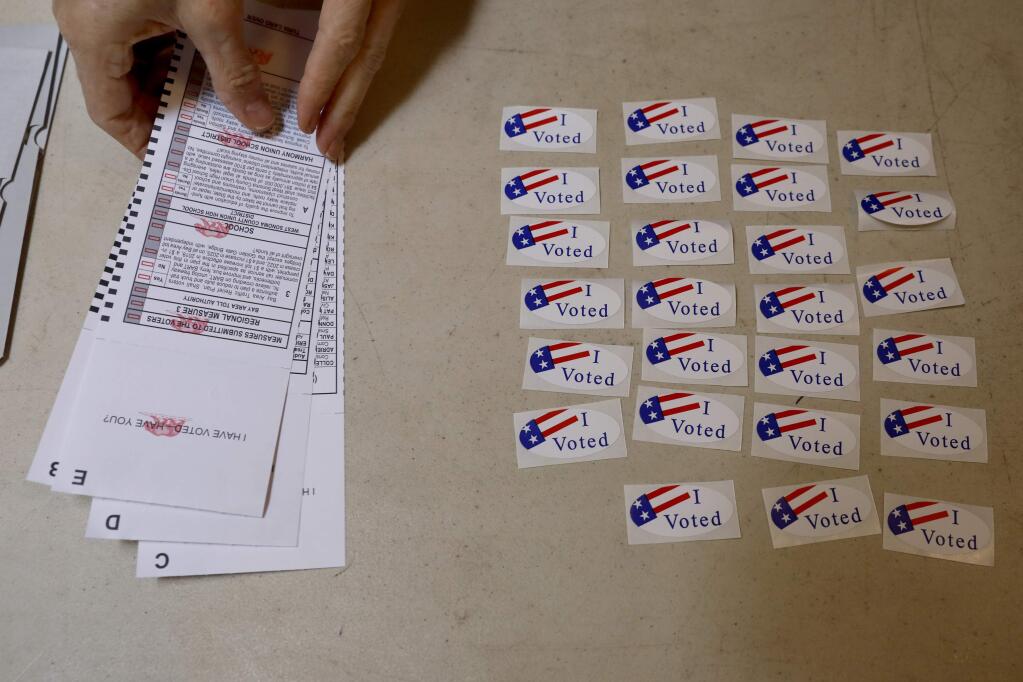 'I voted' stickers sit on the table next to the ballot box in Anderson Hall on Tuesday, June 5, 2018 in Camp Meeker, California . (BETH SCHLANKER/The Press Democrat)