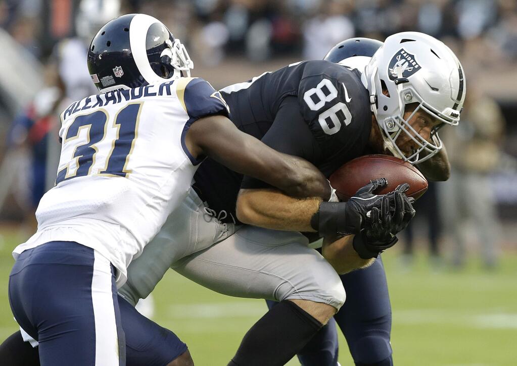 Oakland Raiders tight end Lee Smith (86) catches a touchdown pass against Los Angeles Rams free safety Maurice Alexander (31) during the first half of a preseason game in Oakland, Saturday, Aug. 19, 2017. (AP Photo/Rich Pedroncelli)