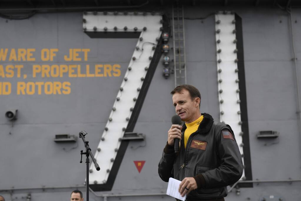 CORRECTS YEAR TO 2019, NOT 2029 - In this Nov. 15, 2019, photo U.S. Navy Capt. Brett Crozier, commanding officer of the aircraft carrier USS Theodore Roosevelt (CVN 71), addresses the crew during an all-hands call on the ship's flight deck while conducting routine operations in the Eastern Pacific Ocean. U.S. defense leaders are backing the Navy's decision to fire the ship captain who sought help for his coronavirus-stricken aircraft carrier, even as videos showed his sailors cheering him as he walked off the vessel. Videos went viral on social media Friday, April 3, 2020, showing hundreds of sailors gathered on the ship chanting and applauding Navy Capt. Brett Crozier as he walked down the ramp, turned, saluted, waved and got into a waiting car. (U.S. Navy Photo by Mass Communication Specialist 3rd Class Nicholas Huynh via AP)