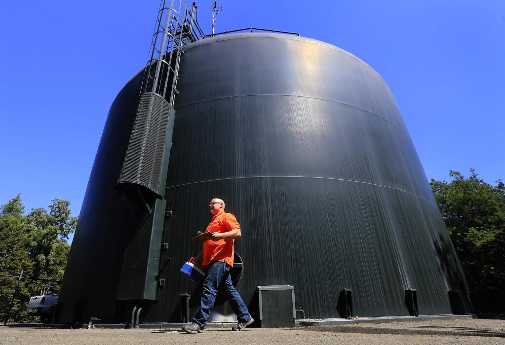 Valley of the Moon Water District maintenance worker Brian Larson walks past a 350,000 gallon water tank in the hills above Agua Caliente in the Sonoma Valley. (Photo by John Burgess)