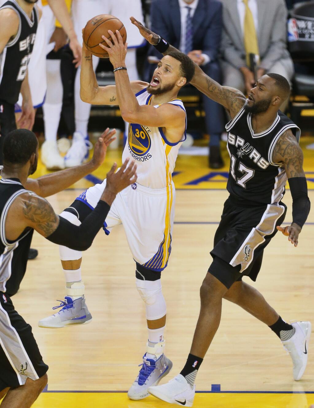 Golden State Warriors guard Stephen Curry goes up for s layup against San Antonio Spurs guard Jonathon Simmons, during game 1 of the NBA Western Conference Finals in Oakland on Sunday, May 14, 2017. The Warriors defeated the Spurs 113-111.(Christopher Chung/ The Press Democrat)