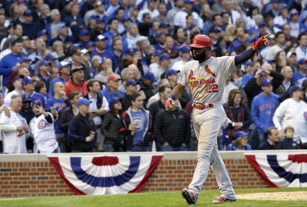 St. Louis Cardinals' Jason Heyward (22) reacts as he scores a run on an RBI double by Tony Cruz during the sixth inning of Game 4 in baseball's National League Division Series against the Chicago Cubs, Tuesday, Oct. 13, 2015, in Chicago. (AP Photo/Nam Y. Huh)