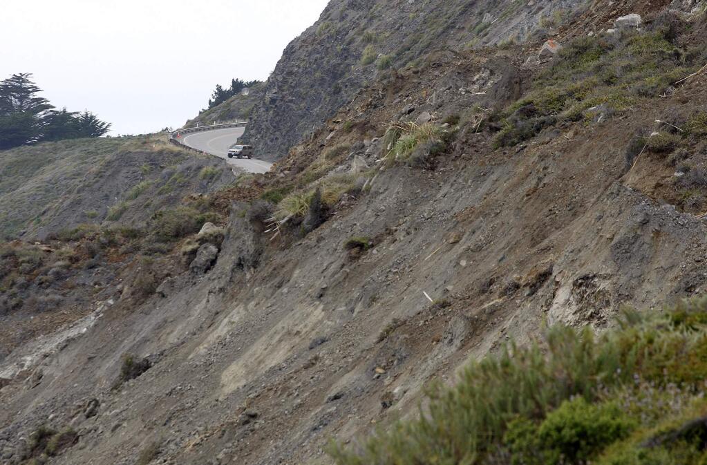A car turns around on Highway One at the north section of the Mud Creek slide as it covers Highway One in southern Monterey County on the coast of Big Sur, in Calif., Thursday, May 25, 2017. One of the wettest winters in decades in California has triggered slides and road closures along the central coast's Big Sur, forcing some resorts to close and others to use helicopters to carry in guests and supplies. (Vern Fisher/The Monterey County Herald via AP)