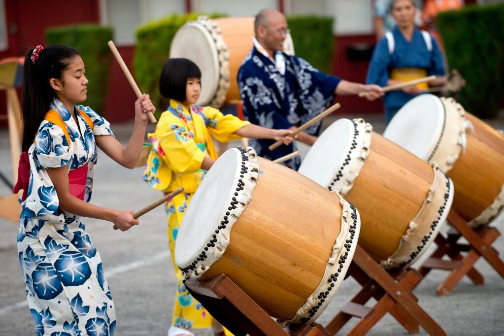 Maki Mizutani, 13, left, Ren Zoshi, 12, and Arnold Shimizu perform with Sonoma County Taiko during the Obon Festival at Enmanji Buddhist Temple in Sebastopol, California, on July 19, 2014. (Alvin Jornada / For The Press Democrat)