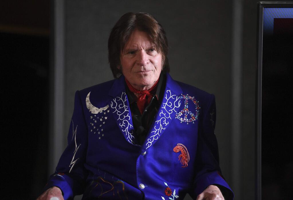 In this March 19, 2019 photo, Musician John Fogerty participates in the Woodstock 50 lineup announcement at Electric Lady Studios in New York. Fogerty has pulled out of Woodstock 50 weeks before the trouble anniversary event is supposed to take place. A representative for the singer tells The Associated Press that Fogerty, who performed at the original festival in 1969, will now only perform at a smaller Woodstock anniversary event held at the original site in Bethel, N.Y. (Photo by Evan Agostini/Invision/AP, File)