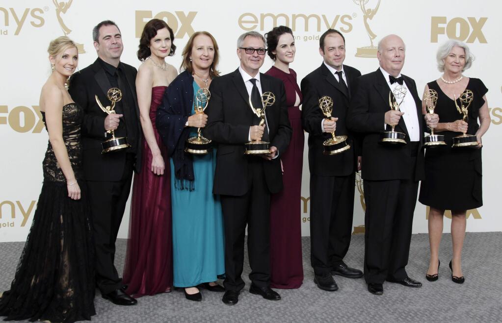 FILE - In this Sept. 18, 2015 file photo, 'Downton Abbey' cast members, writers and producers pose with their first Emmys for outstanding writing and outstanding miniseries or movie at the 63rd Primetime Emmy Awards. The producers of 'Downton Abbey' announced on Thursday, March 26, 2015, that the upcoming sixth season of the drama series will be its last. (AP Photo/Jae Hong, File)