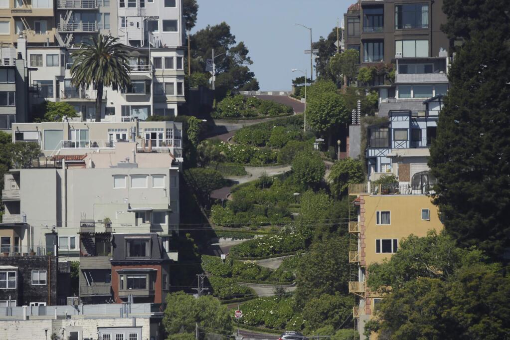 In this April 24, 2020, photo, crooked Lombard Street is seen empty in San Francisco. San Francisco's mayor is under growing pressure to house all of the city's 8,000 homeless residents in hotel rooms left empty by the coronavirus pandemic. (AP Photo/Eric Risberg)