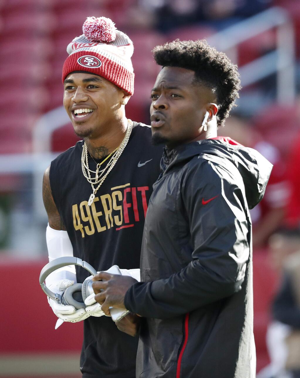 San Francisco 49ers wide receiver Kendrick Bourne, left, talks with wide receiver Marquise Goodwin before an NFL football game against the Chicago Bears in Santa Clara, Calif., Sunday, Dec. 23, 2018. (AP Photo/Tony Avelar)