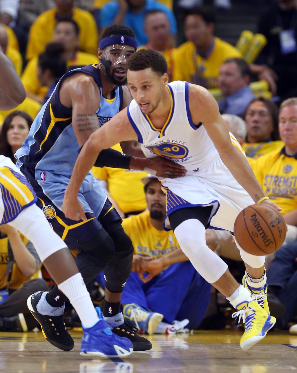 Golden State Warriors guard Stephen Curry drives around Memphis Grizzlies guard Mike Conley during Game 5 of the NBA Playoffs Western Conference Semifinals at Oracle Arena, in Oakland on Wednesday, May 13, 2015. The Warriors defeated the Grizzlies 98-78.(Christopher Chung/ The Press Democrat)