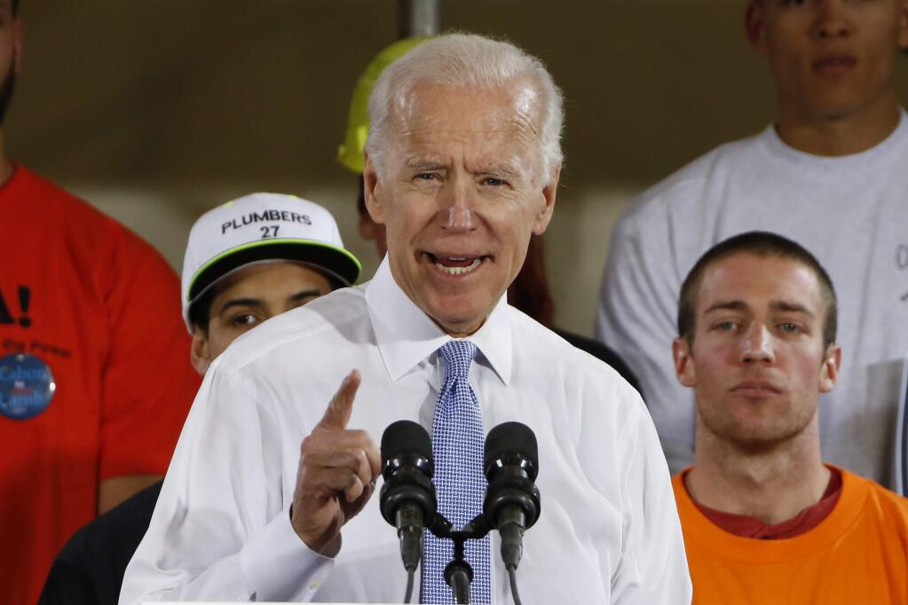 FILE - In this March 6, 2018 file photo, former Vice President Joe Biden speaks at a rally in support of Conor Lamb, the Democratic candidate for the March 13 special election in Pennsylvania's 18th Congressional District in Collier, Pa. Biden says he would “beat the hell” out of President Donald Trump in high school if Trump disrespected women. He spoke Tuesday at an anti-sexual assault rally at the University of Miami. (AP Photo/Gene J. Puskar, File)