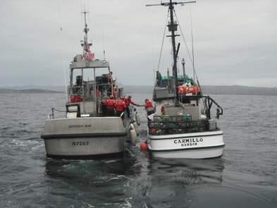 BODEGA BAY, Calif. -- A 47-foot Motor Life Boat, from Station Bodega Bay, pulls alongside the fishing vessel Carmillo to transfer an injured fisherman to shore, Nov. 19, 2010. Station Bodega Bay crewmembers transported the injured man to shore for further medical assistance. U.S. Coast Guard photo by Station Bodega Bay.