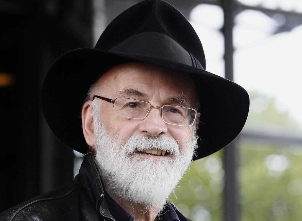FILE - This is a Tuesday, Oct. 5, 2010 file photo of British author Terry Pratchett seen at the Conservative party conference in Birmingham, England. Fantasy writer Pratchett, creator of the ìDiscworldî series died Thursday March 12, 2015 aged 66. Pratchett, who suffered from a very rare form of early onset Alzheimer's disease, had earned wide respect throughout Britain with his dignified campaign for the right of critically ill patients to choose assisted suicide. (AP Photo/Kirsty Wigglesworth, File)