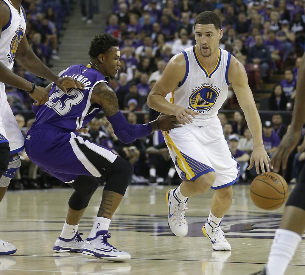 Golden State Warriors guard Klay Thompson, right, drives against Sacramento Kings guard Ben McLemore during the first quarter of an NBA basketball game in Sacramento, Calif., Wednesday Oct. 29, 2014. The Warriors won 95-77.(AP Photo/Rich Pedroncelli)