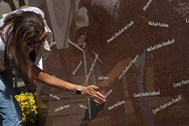 Victoria Evans touches the name of her mother-in-law Valerie Lynn Evans who died in the October 2017 Tubbs fire at her home on Coffey Lane. Evans attended the sculpture dedication honoring the 2017 wildfire victims held Sunday at Luther Burbank Center for the Arts in Santa Rosa, California. October 6, 2019. (Photo: Erik Castro/for The Press Democrat)