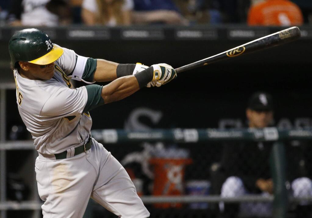 Oakland Athletics' Khris Davis hits a two-run home run during the third inning against the Chicago White Sox in Chicago, Friday, Aug. 19, 2016. (AP Photo/Nam Y. Huh)