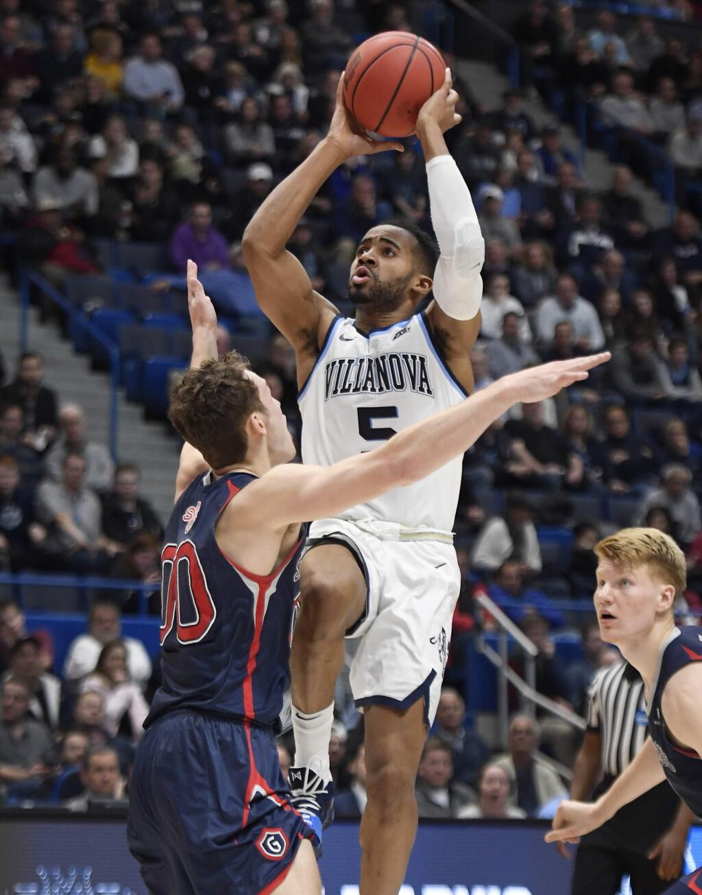 Villanova's Phil Booth (5) shoots over St. Mary's Tanner Krebs (0) during the first half of a first round men's college basketball game in the NCAA tournament, Thursday, March 21, 2019, in Hartford, Conn. (AP Photo/Jessica Hill)