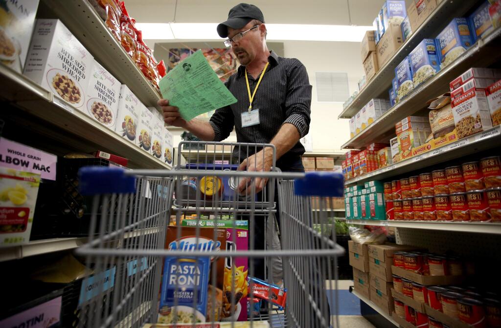 PHOTO: 1 no credit PHOTO: 1 by CRISTA JEREMIASON / The Press Democrat -Volunteer Doral Borgnis pulls items for a customer at Food for Thought in Forestville.