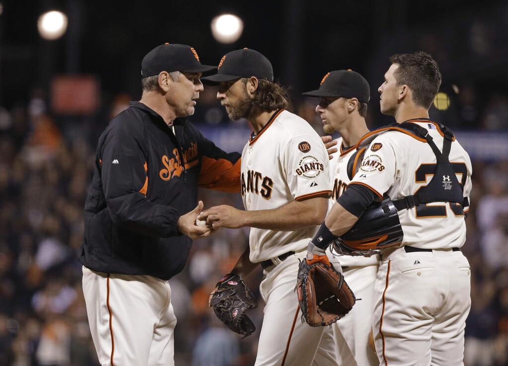 San Francisco Giants manager Bruce Bochy, left, removes starting pitcher Madison Bumgarner, second from left, during the eighth inning of the Giants' baseball game against the San Diego Padres on Tuesday, June 23, 2015, in San Francisco. At right is catcher Giants' Buster Posey and second from right is third baseman Matt Duffy. (AP Photo/Eric Risberg)