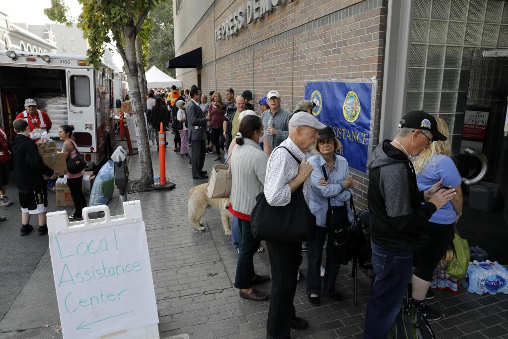 People line up outside the FEMA hub at 427 Mendocino Ave in Santa Rosa, on Monday, October 16, 2017. (BETH SCHLANKER/ The Press Democrat)