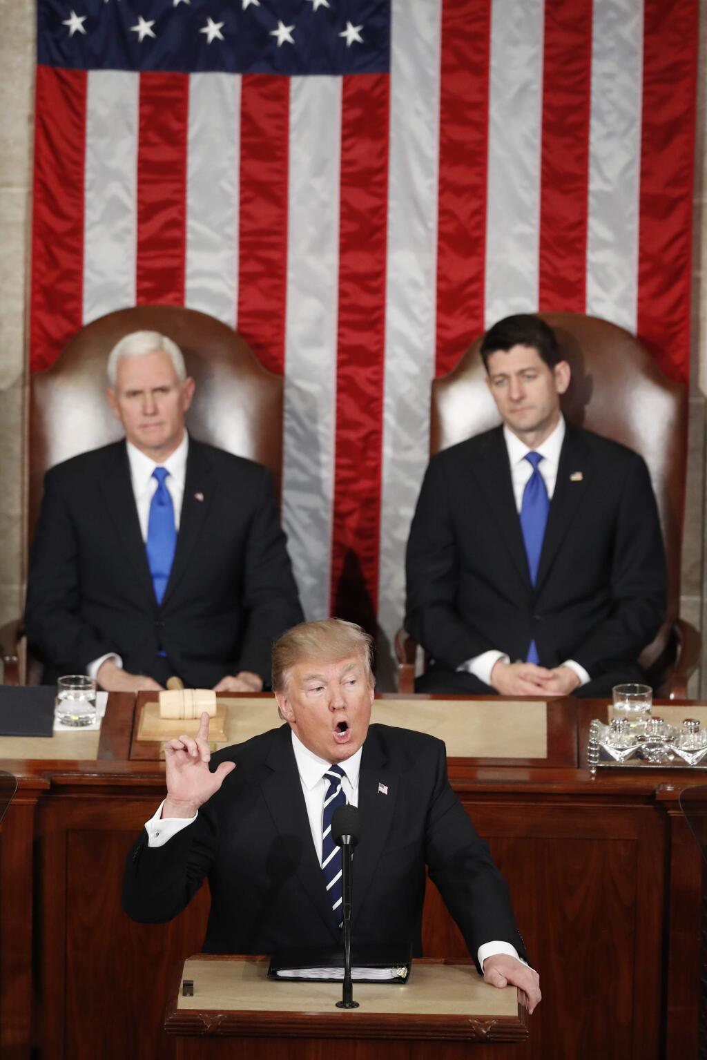 President Donald Trump, flanked by Vice President Mike Pence and House Speaker Paul Ryan of Wis. gestures as he addresses a joint session of Congress on Capitol Hill in Washington, Tuesday, Feb. 28, 2017. (AP Photo/Alex Brandon)