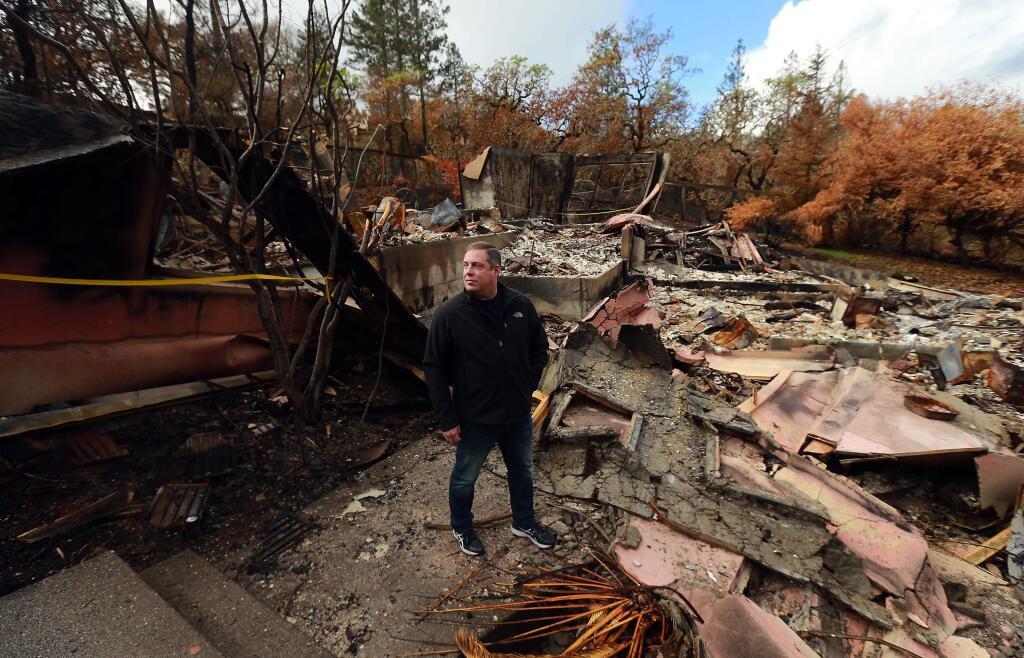 Aaron Groves decided to use a private company instead of the Army Corps of Engineers to clean the remains of his Shelter Glen Ct. home in Fountaingrove . (photo by John Burgess/The Press Democrat)