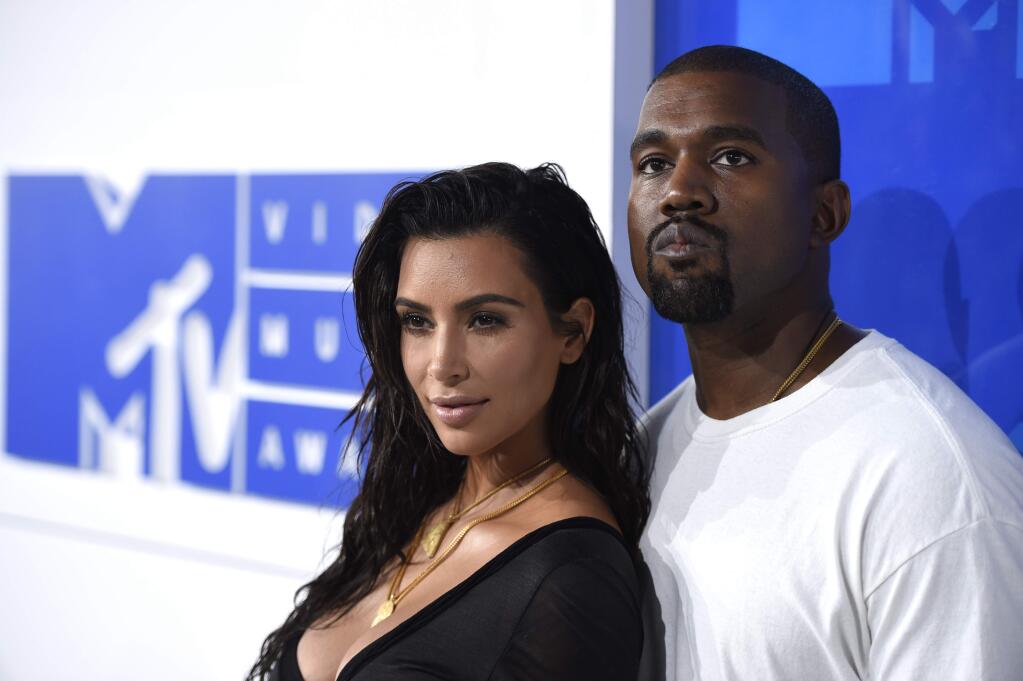 FILE - In this Aug. 28, 2016 file photo, Kim Kardashian West, left, and Kanye West arrive at the MTV Video Music Awards in New York. (Photo by Evan Agostini/Invision/AP, File)