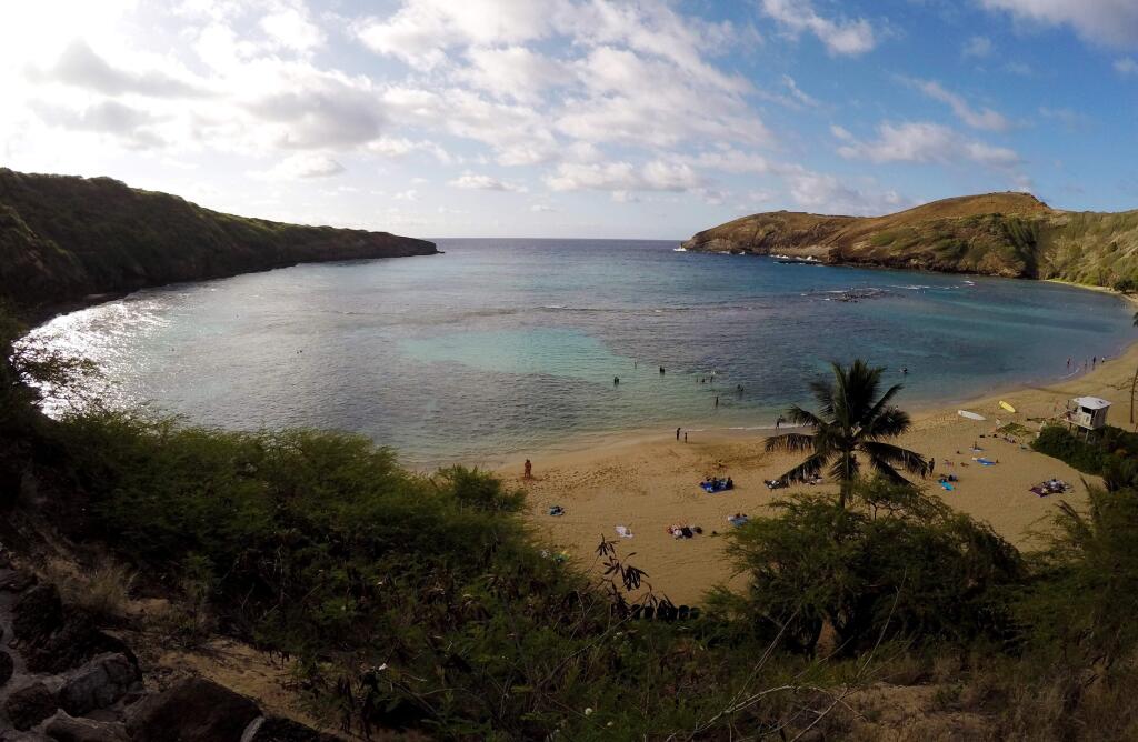 In this May 11, 2016 photo, people swim in Oahu's Hanauma Bay near Honolulu. Hanauma Bay is No. 1 on the list of best beaches for the summer of 2016 compiled by Stephen Leatherman, also known as Dr. Beach, a professor at Florida International University. (AP Photo/Caleb Jones)