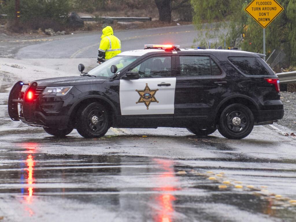 An Orange County Sheriff vehicle closes Trabuco Canyon Road in Trabuco Canyon, Calif. Orange County has agreed to pay $480,000 to a former inmate who was pregnant but suffered a miscarriage after sheriff’s deputies stopped at a Starbucks while driving her to a hospital.(Mark Rightmire/The Orange County Register via AP)