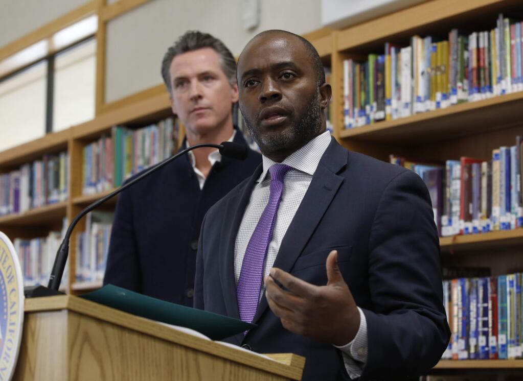 FILE - In this Oct. 31, 2019, file photo, state Superintendent of Public Instruction Tony Thurmond answers a reporter's question during a visit with California Gov. Gavin Newsom, background, to Blue Oak Elementary School, in Cameron Park, Calif. (AP Photo/Rich Pedroncelli, File)