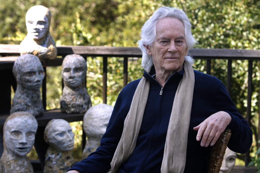 FILE - In this Sept. 16, 2010, file photo, beat poet Michael McClure is seen on his deck with sculptures by his wife, artist Amy Evans McClure, at their home in Oakland, Calif. Michael McClure, one of the famed Beat poets of San Francisco who went on a career as a poet that eclipsed most others in popular culture, has died. The San Francisco Chronicle reported that McClure died Tuesday, May 5, 2020, in Oakland, Calif., after suffering a stroke last year. He was 87. (Paul Chinn/San Francisco Chronicle via AP)