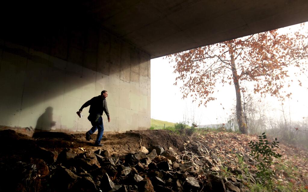 Dean Talent of Santa Rosa searches for the homeless under the Dutton Ave. bridge at Santa Rosa Creek in Santa Rosa, during Sonoma County's homeless count in 2015. (Kent Porter / Press Democrat)