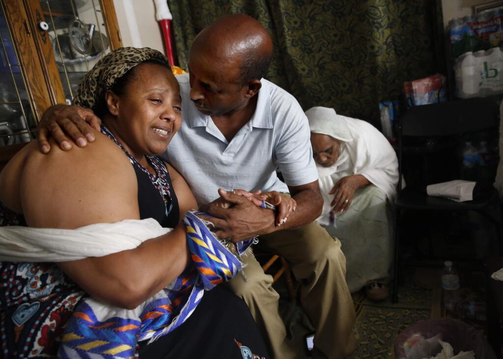 Elsa Tewoldeberhan, the mother of Cirak Mateos Tesfazgi, who was stabbed to death early Monday, is comforted by Mengistab Gebre, a family friend, at her home in Santa Rosa, on Tuesday, June 28, 2016. (BETH SCHLANKER/ The Press Democrat)