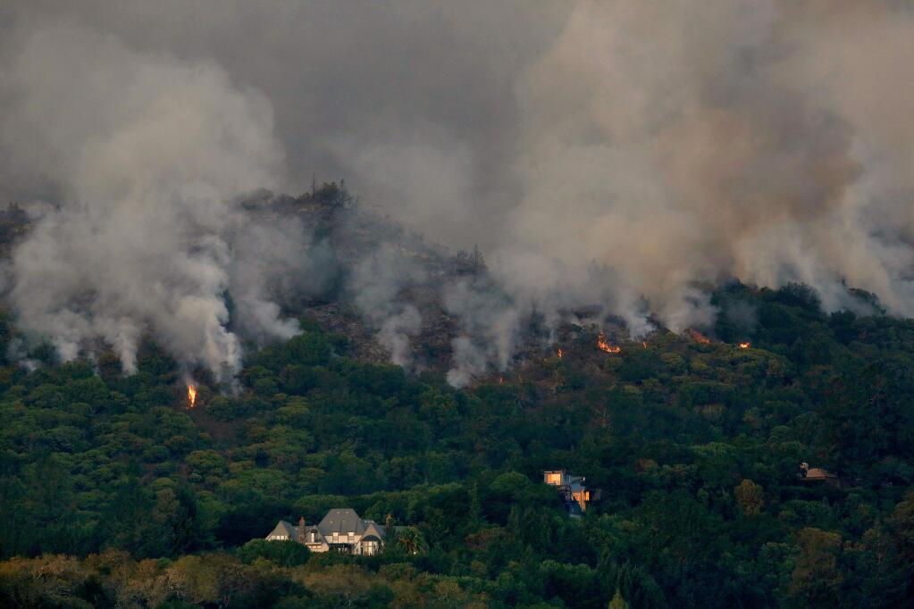 Flames from the Southern Complex fire creep downhill toward homes overlooking Kenwood Vineyards, in Kenwood, California, on Tuesday, October 10, 2017. (Alvin Jornada / The Press Democrat)