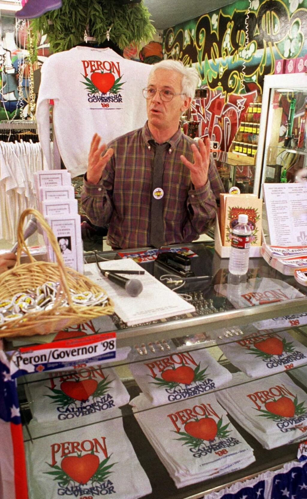 FILE - In this Jan. 17, 1998 file photo, California Republican gubernatorial candidate Dennis Peron gestures while speaking to supporters at the Rainbow Smoke Shop in San Jose, Calif. Peron, an activist who was among the first people to argue for the benefits of marijuana for AIDS patients and helped legalize medical pot in California, died Saturday, Jan. 27, 2018, at 72. The San Francisco Chronicle reported that Peron died in a hospital in the city. (AP Photo/Darryl Bush, File)