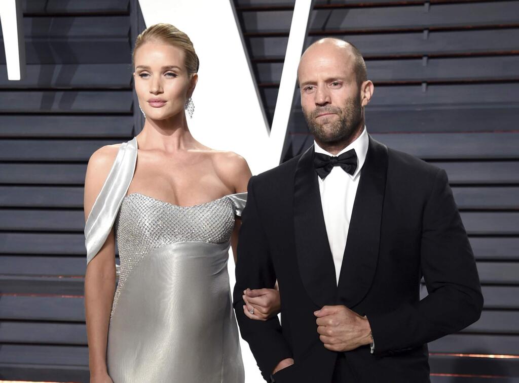 FILE - In this Feb. 26, 2017 file photo, Rosie Huntington-Whiteley, left, and Jason Statham arrive at the Vanity Fair Oscar Party in Beverly Hills, Calif. Huntington-Whiteley and her fiancv© Statham welcomed son Jack Oscar Statham, born on June 24 weighing 8.8 pounds. She announced the birth and included a photo in an Instagram post on Wednesday, June 28. (Photo by Evan Agostini/Invision/AP, File)
