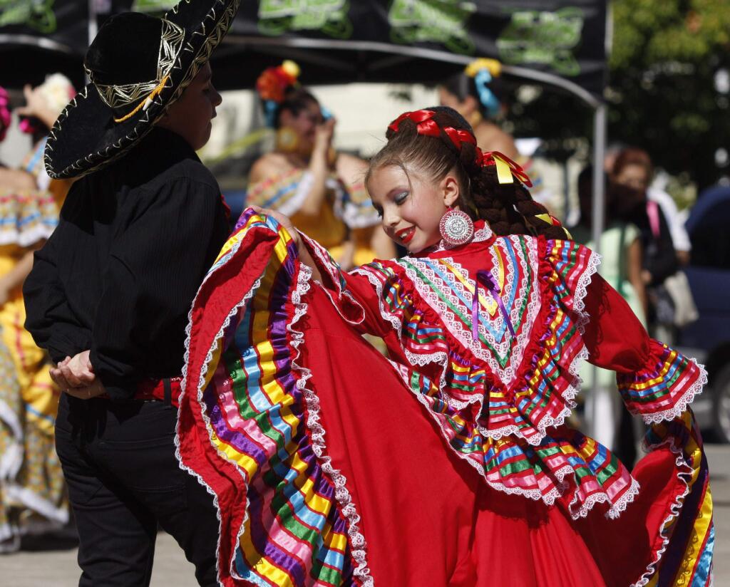 Isabel Barajas, 8, and Nicolas Garcia, 9, dance at the El Dia de Los Muertos Kickoff Celebration and Health Fair in the plaza of St. Vincent de Paul Catholic Church in Petaluma on Sunday, October 5, 2014.(SCOTT MANCHESTER/ARGUS-COURIER STAFF)