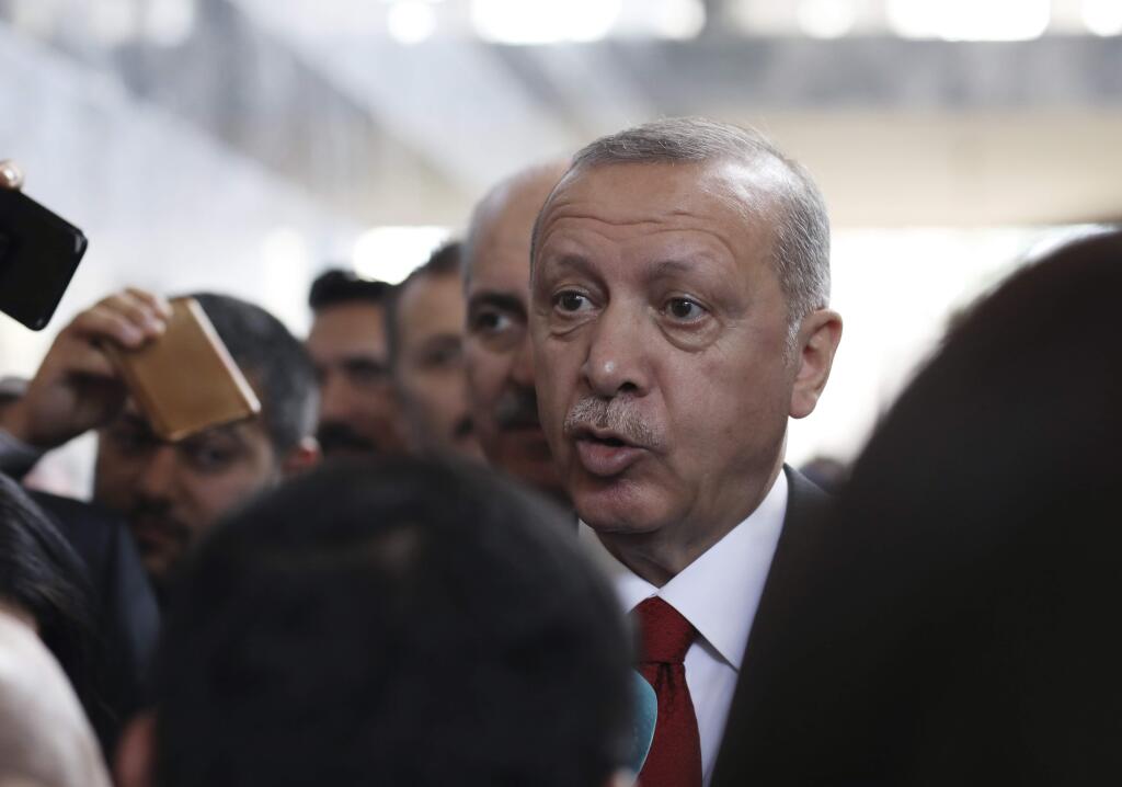 Turkish President Recep Tayyip Erdogan speaks to journalists at the Parliament, in Ankara, Tuesday, Nov. 5, 2019. Erdogan called on Russia and the United States on Tuesday to keep to their promises to ensure that Syrian Kurdish fighters pull out of Syrian borders areas with Turkey.(AP Photo/Burhan Ozbilici)