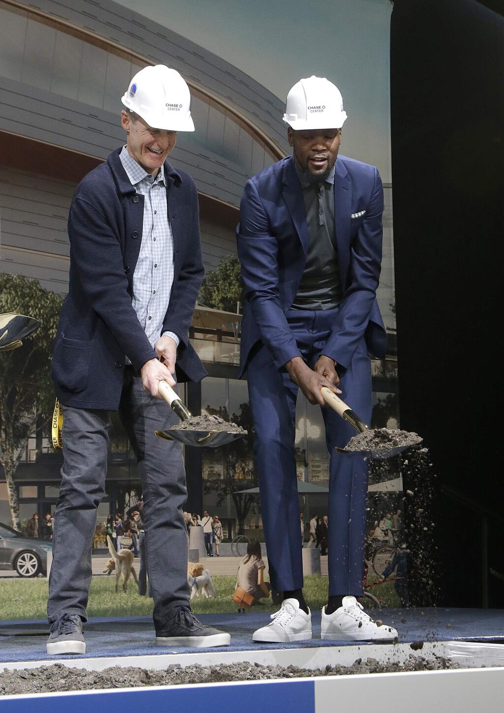Golden State Warriors head coach Steve Kerr, left, and forward Kevin Durant shovel dirt while posing for photos during a ground breaking ceremony for the Chase Center in San Francisco, Tuesday, Jan. 17, 2017. (AP Photo/Jeff Chiu)