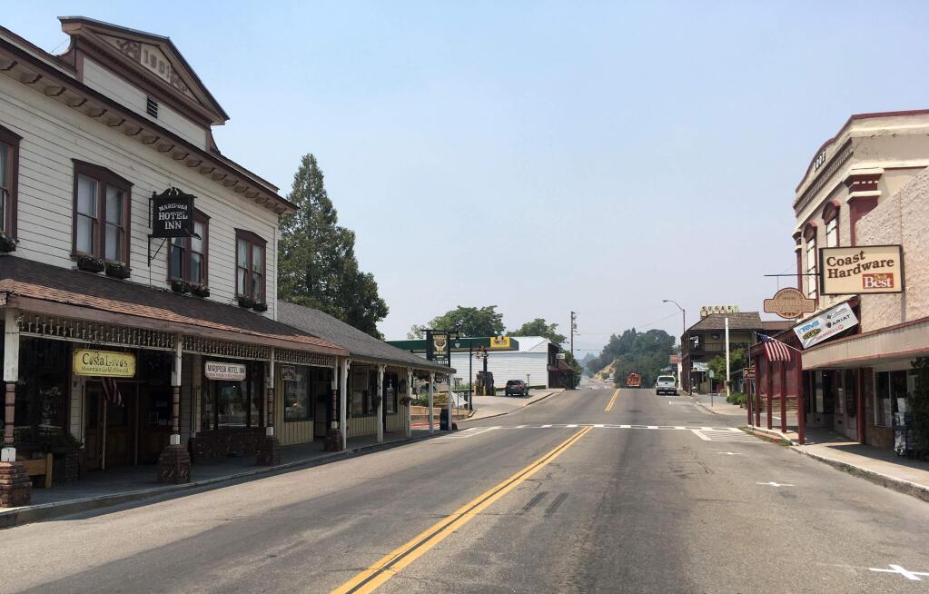 The evacuated downtown of Mariposa, Calif., is viewed Thursday July 20, 2017, as firefighters battle a large wildfire in the surrounding hills and mountains. Mariposa normally bustles with tourists on their way to Yosemite National Park. The town's center is made up of old brick and wooden buildings in the holding modern clothing and gift shops, restaurants and wine bars. (AP Photo/Scott Smith)