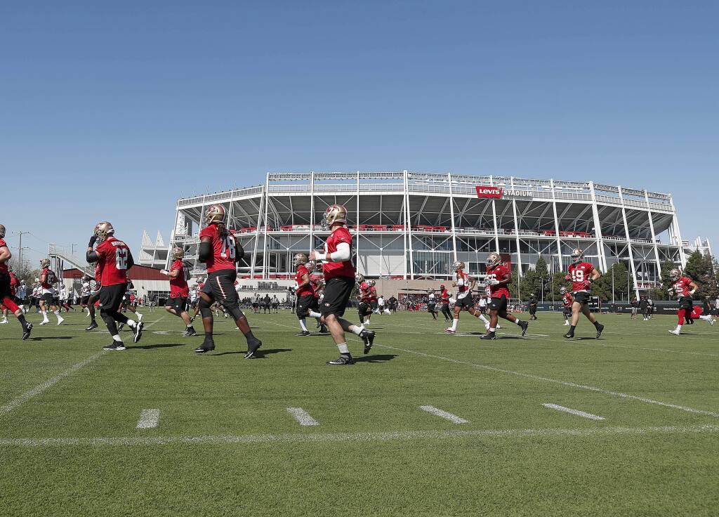 San Francisco 49ers players warm up during practice at the team's headquarters Friday, July 27, 2018, in Santa Clara. (AP Photo/Tony Avelar)