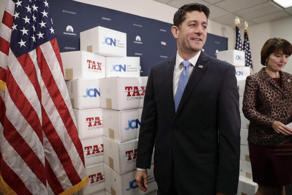 Speaker of the House Paul Ryan, R-Wis., followed at right by Rep. Cathy McMorris Rodgers, R-Wash., walks past boxes of petitions supporting the Republican tax reform bill that is set for a vote later this week as he arrives for a news conference on Capitol Hill in Washington, Tuesday, Nov. 14, 2017. (AP Photo/J. Scott Applewhite)