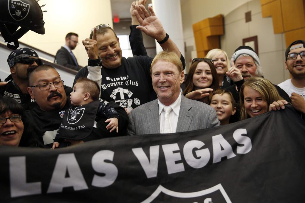 In this April 28, 2016, file photo, Oakland Raiders owner Mark Davis, center, meets with Raiders fans after speaking at a meeting of the Southern Nevada Tourism Infrastructure Committee in Las Vegas. (AP Photo/John Locher, File)