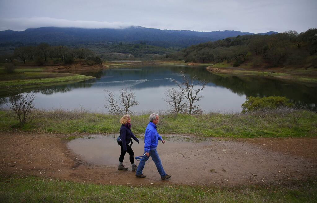 Paula Reimers and Charles Cronin walk along the perimeter of Suttonfield Lake in Sonoma Valley Regional Park, near Glen Ellen, on Friday, January 8, 2016. (Christopher Chung/ The Press Democrat)