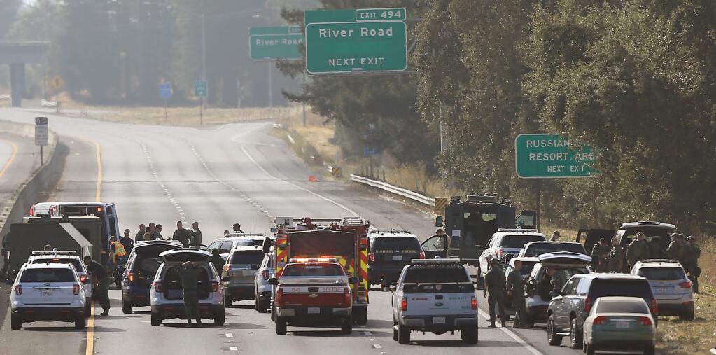 The California Highway Patrol and the Sonoma County Sheriff's Department wrap up a standoff on south Highway 101, between the Fulton Road overcrossing and River Road, Sunday, Sept. 15, 2019. The subject was taken in to custody after officers fired a flash bang device in to the vehicle. (KENT PORTER/ PD)