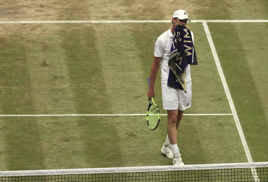 Sam Querrey of the United States walks back to his seat as he plays his Men's Singles semifinal match against Croatia's Marin Cilic on day eleven at the Wimbledon Tennis Championships in London, Friday, July 14, 2017. (Daniel Leal-Olivas/Pool Photo via AP)