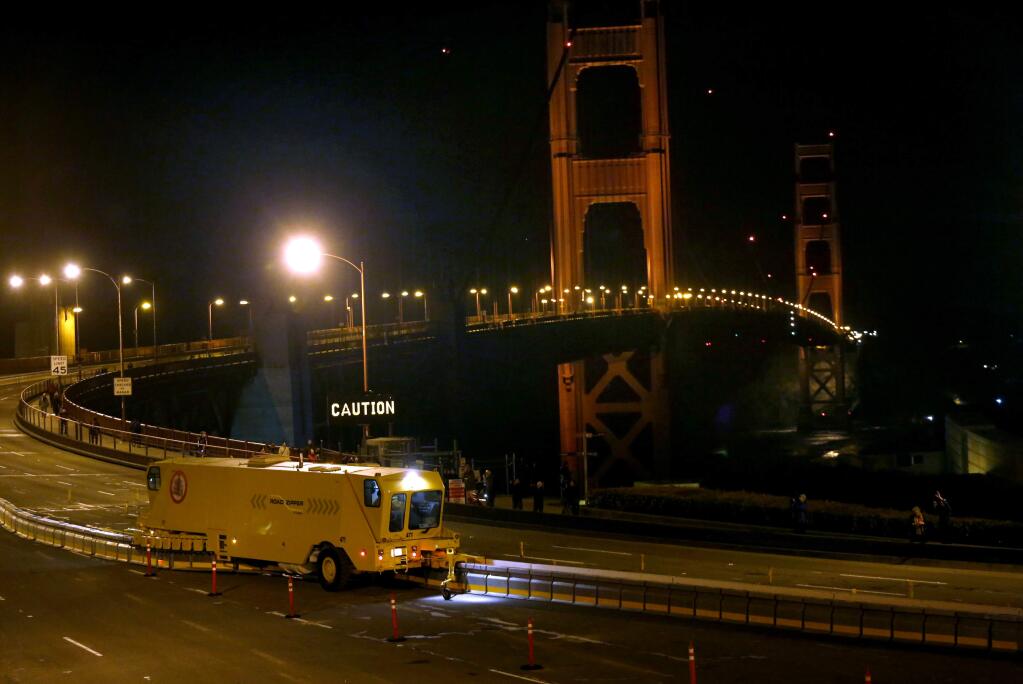 Crews practice using a zipper truck to move the new lane barrier on the Golden Gate Bridge on Sunday, January 11, 2015 in San Francisco, California . (BETH SCHLANKER/ The Press Democrat)